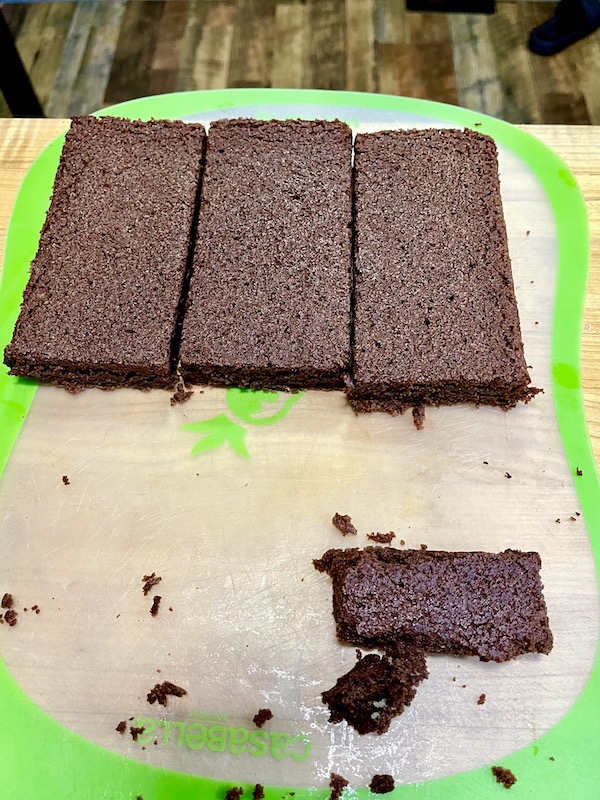Half a tray of RhoRho's Brownies have been cut.