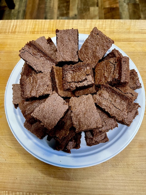 A white plate topped with a spiral of cut RhoRho's Brownies