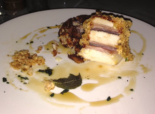 A white plate with a stack of chicken and ham.