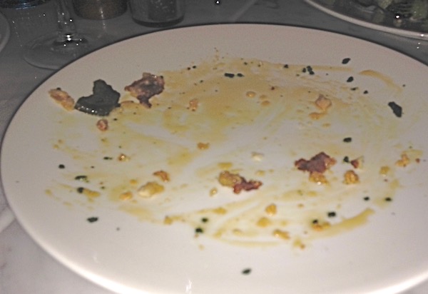 A white plate with crumbs.