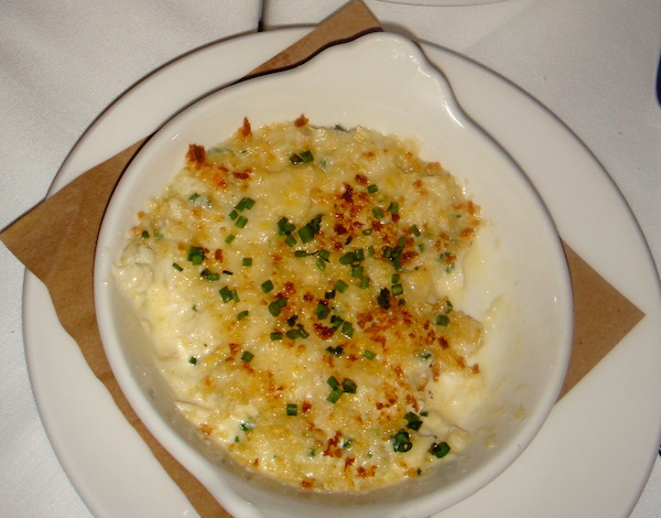 A white plate filled with Baked Blue Crab with Brie and Chives au Gratin