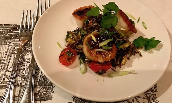 Seared Sea Scallops with Creamy Grits and Tomato Stewed Okra on a white plate