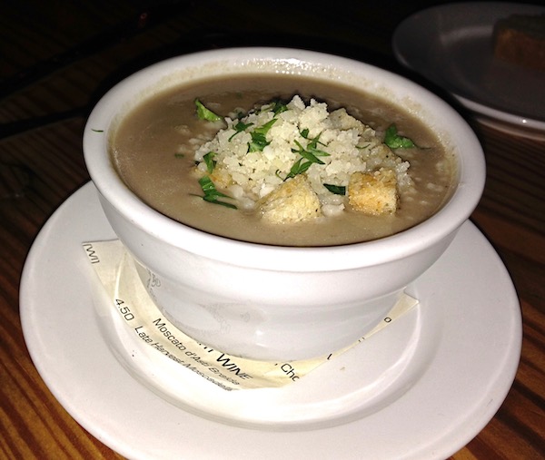 A white bowl filled with cream of mushroom soup