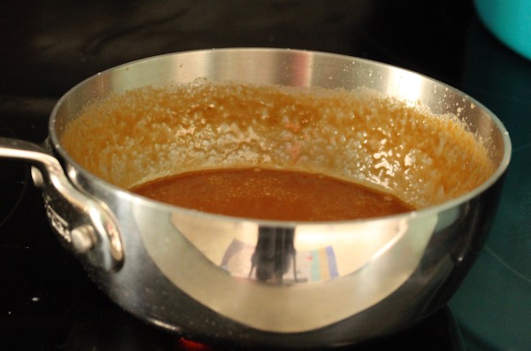 Saucepan with amber brown caramel in it.