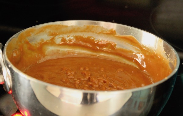 Saucepan with amber brown caramel in it.