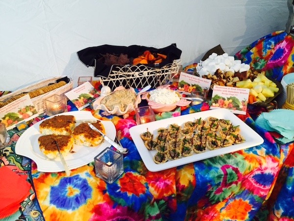 A small portion of a colorful buffet table with food