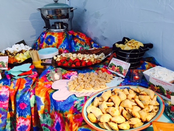 A small portion of a colorful buffet table with food