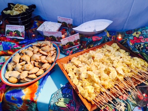 Two platters of small bites on a colorful cloth