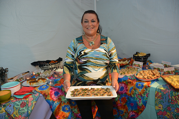 A woman holding a platter of hors d'oeuvres