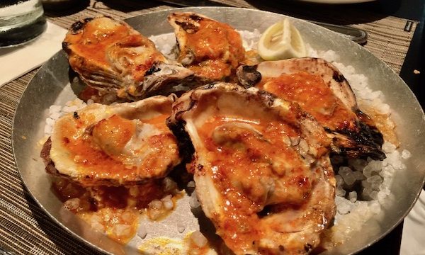 A platter of Wood Fired Oysters with Chile Garlic Butter