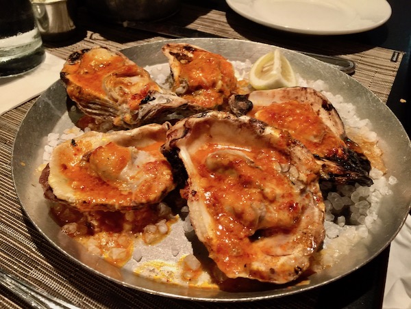 A platter of Wood Fired Oysters with Chile Garlic Butter