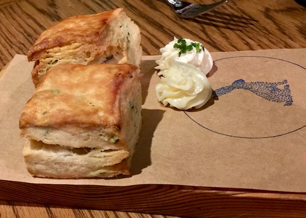 Conch Croquettes on a wood board covered with brown paper