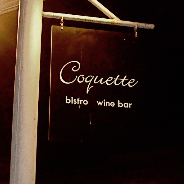 The exterior of a restaurant with a sign the reads Coquette Bistro and Wine Bar