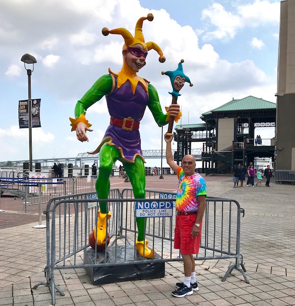 A court jester statue and a man in shorts