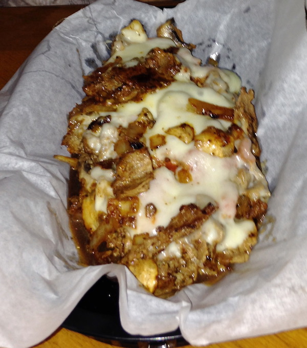 A cheesesteak on white deli paper