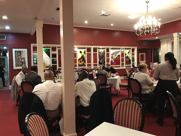 An elegant restaurant dining room with dark red walls