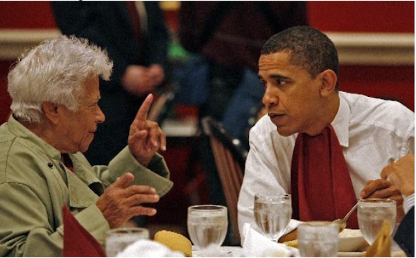 A framed photo of President Barack Obama Deep in Discussion with Chef Leah Chase who is wearing a pale green chef coat