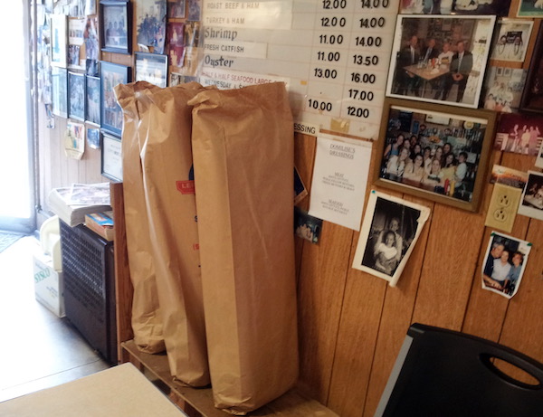 Tall bags of fresh bread against a wall