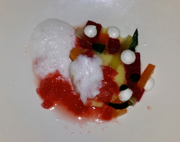 A plate of multicolored gelatins, meringue dots and white foam
