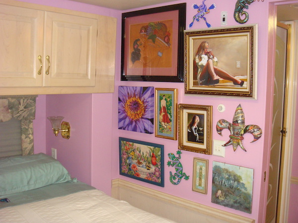 RV bedroom with mauve walls, bed and artwork
