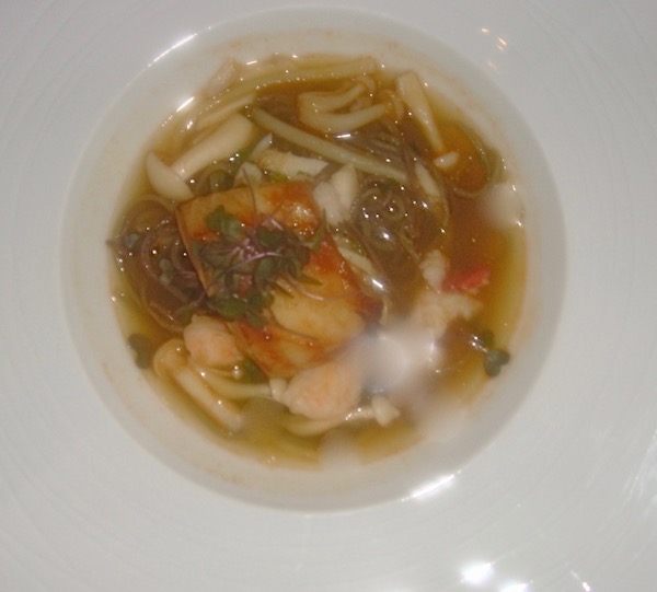 White bowl with Sea bass, lobster, crab and broth