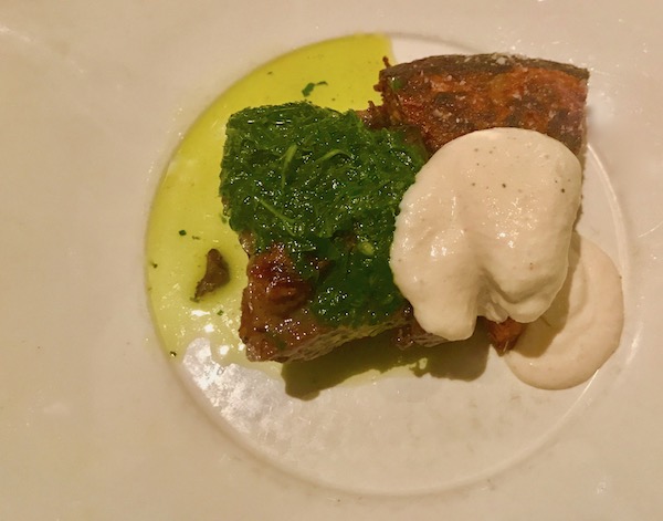Beef Short Rib with Potato Rösti, Salsa Verde and Horseradish Sauce on a white plate