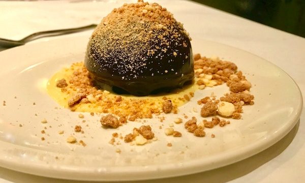 Malted Milk Chocolate Mousse with Malted Crème Anglaise and crumbs on a white plate