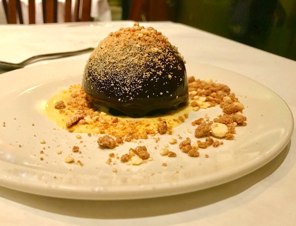 Malted Milk Chocolate Mousse with Malted Crème Anglaise and crumbs on a white plate