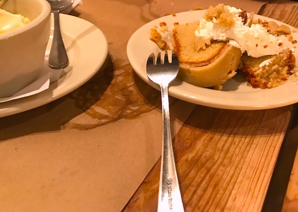 A wite plate with a slice of Sweet Potato Layer Cake and a scoop of ice cream