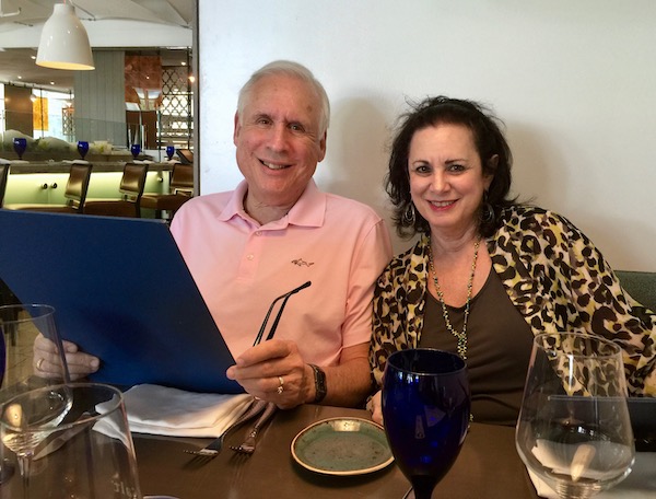 A man and a woman reading a menu in a restaurant