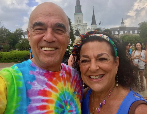 A man and a woman with Jackson Square behind them