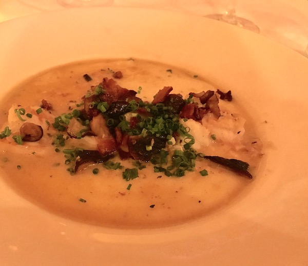 Shrimp and grits in a white shallow bowl