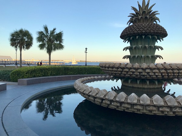 Pineapple Fountain with palm trees in the background