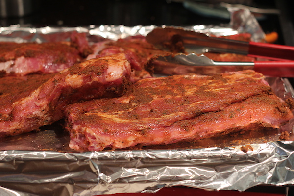 Seasoned ribs on a foil lined sheet pan.