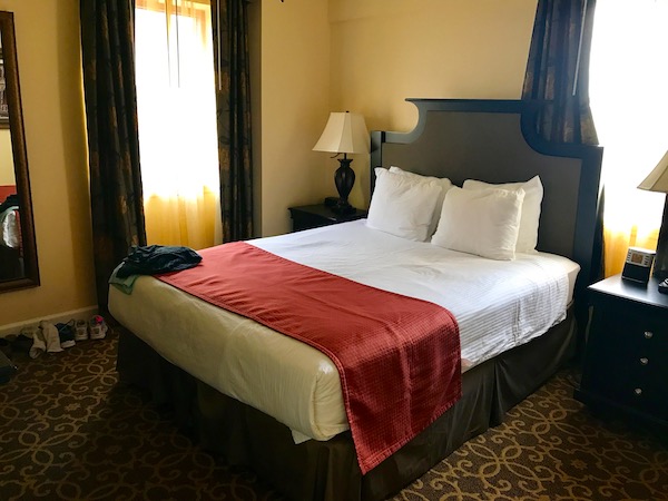 A hotel bedroom with a king sized bed