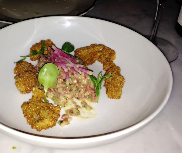 A white plate with Crispy Oysters and Beef Tartare