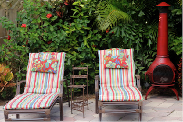 A pair of chaises with striped cushions