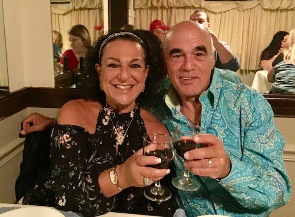 a man and a woman toasting with wine