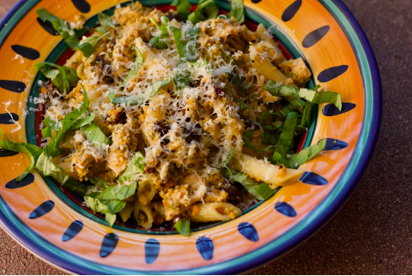Penne with Tuna, Capers and Raisins in a yellow and blue rimmed pasta dish