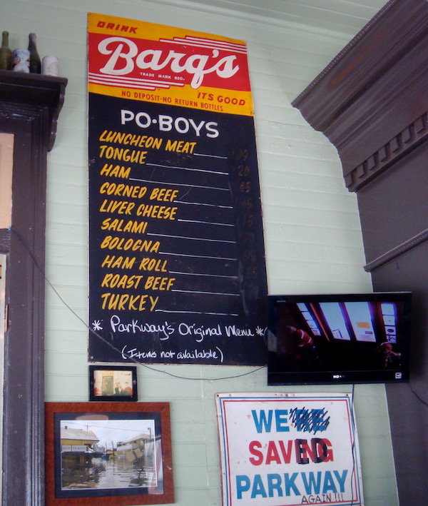 A menu for Po' Boys on the wall of a restaurant