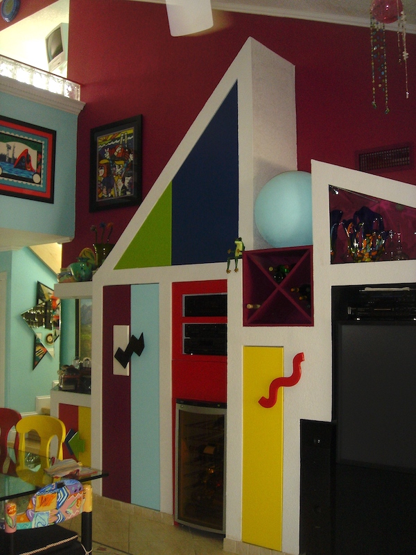 An Art Deco wall unit with peaks and multicolored doors