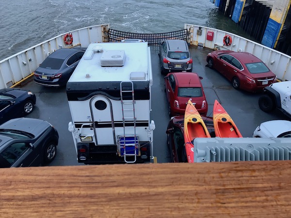 Looking down on cars parked on the bow of a ferry boat