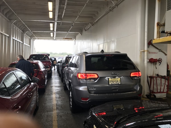 A line up of cars on a ferry boat