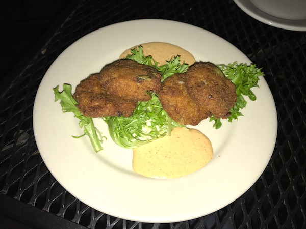 Crab Cakes with Chipotle Remoulade and lettuce on a white plate