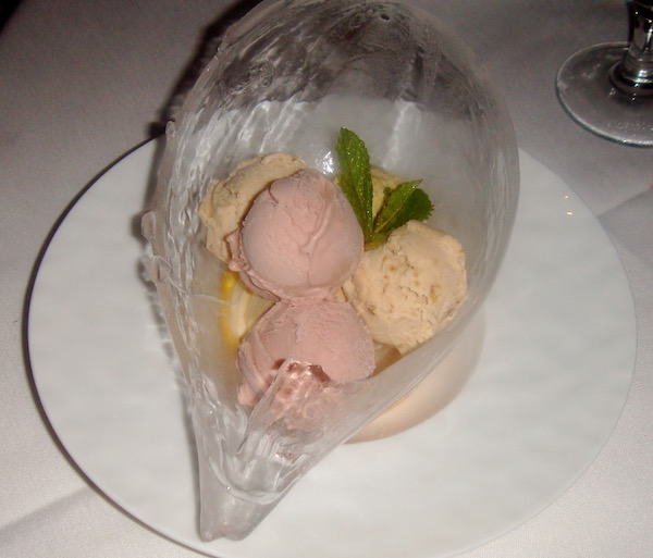 An ice bowl filled with pastel colored sherbet balls and mint leaves