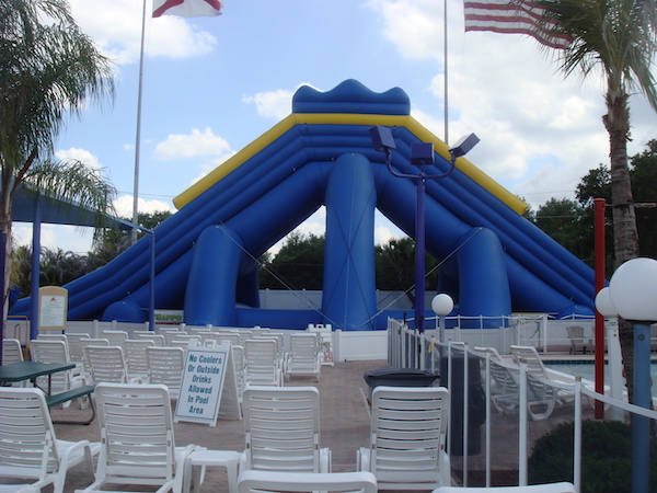 Large blue water slide on pool deck
