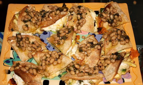 Spicy Hummus and Zucchini Quesadillas with White Bean Relish on a rectangular painted ceramic platter with a deep yellow border