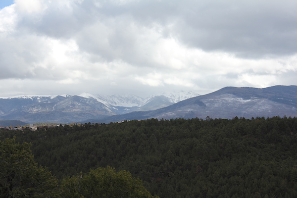 Clouds and snow capped mountains