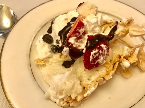 A Slice of Strawberry Pavlova Pie on a white plate with gold edge