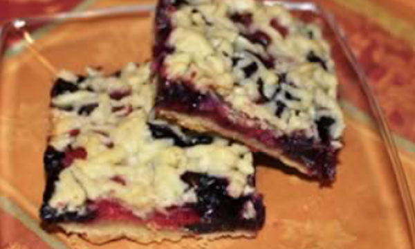 A square gold colored plate with two berry bars